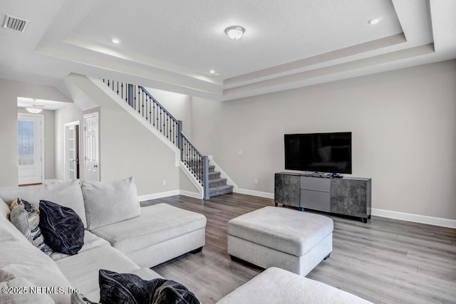23 Catesby Ln, Saint Augustine, FL 32095 - living area featuring a tray ceiling, wood finished floors, stairway, baseboards, and recessed lighting