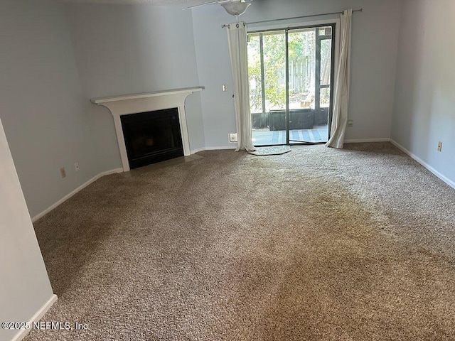3801 Crown Point Rd Unit 1033, Jacksonville, FL 32257 - unfurnished living room with carpet floors, a fireplace with flush hearth, and baseboards