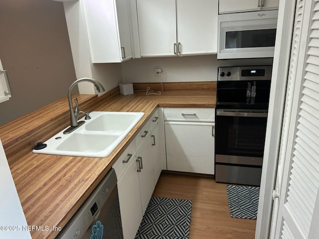 3801 Crown Point Rd Unit 1033, Jacksonville, FL 32257 - kitchen featuring white microwave, a sink, wooden counters, stainless steel dishwasher, and wall oven