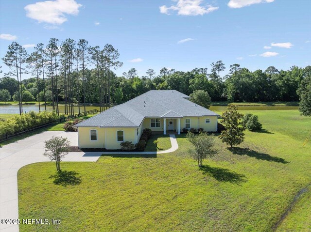 207 Towers Ranch Dr, Saint Augustine, FL 32092 - view of front of house with a front lawn, view of wooded area, a water view, and driveway