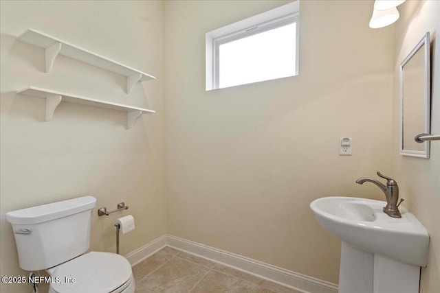 207 Towers Ranch Dr, Saint Augustine, FL 32092 - half bathroom with toilet, baseboards, tile patterned flooring, and a sink