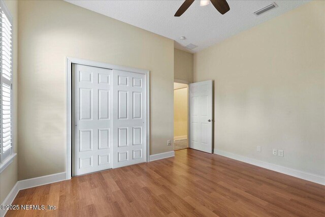 207 Towers Ranch Dr, Saint Augustine, FL 32092 - unfurnished bedroom featuring wood finished floors, a closet, baseboards, and ceiling fan