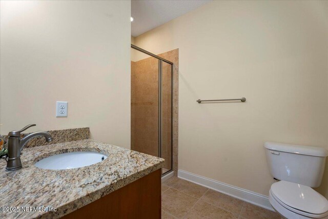207 Towers Ranch Dr, Saint Augustine, FL 32092 - full bathroom with a stall shower, tile patterned flooring, toilet, baseboards, and vanity