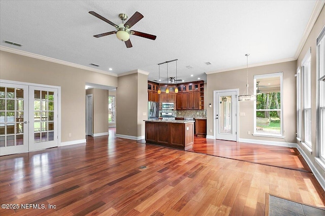 1476 Mallard Landing Blvd, Saint Johns, FL 32259 - unfurnished living room with french doors, a ceiling fan, wood finished floors, crown molding, and plenty of natural light