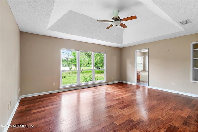 1476 Mallard Landing Blvd, Saint Johns, FL 32259 - spare room with wood finished floors, a ceiling fan, baseboards, a raised ceiling, and a textured ceiling