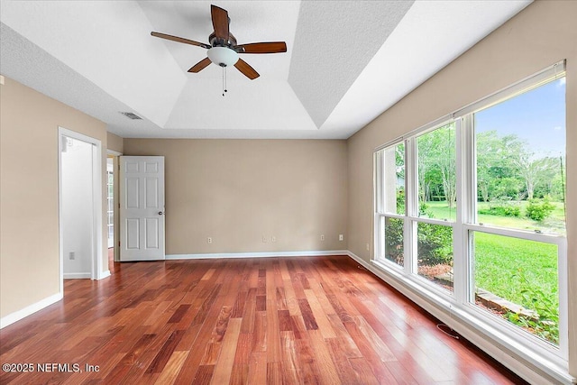 1476 Mallard Landing Blvd, Saint Johns, FL 32259 - spare room featuring a ceiling fan, wood finished floors, baseboards, and a tray ceiling
