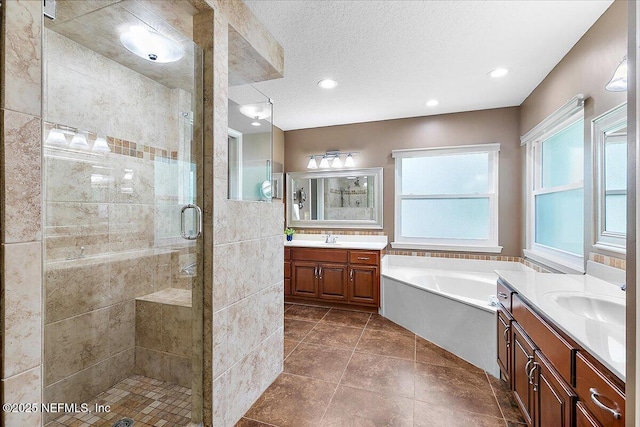 1476 Mallard Landing Blvd, Saint Johns, FL 32259 - full bath featuring a stall shower, two vanities, a garden tub, recessed lighting, and a textured ceiling