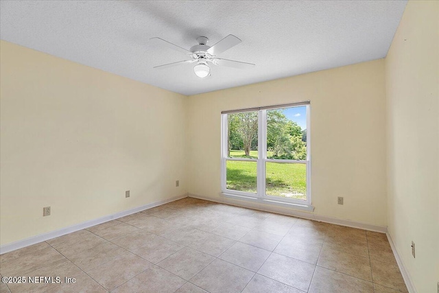 1476 Mallard Landing Blvd, Saint Johns, FL 32259 - empty room featuring a ceiling fan, light tile patterned floors, baseboards, and a textured ceiling
