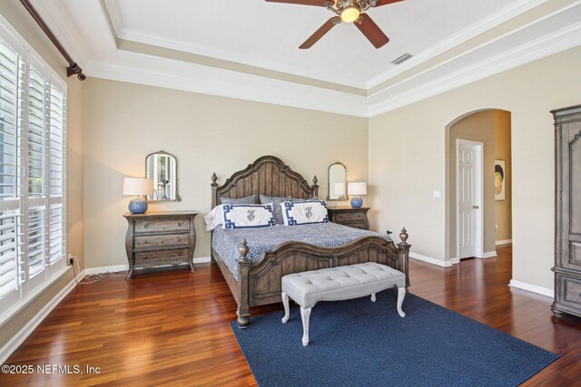 1867 Paradise Moorings Blvd, Middleburg, FL 32068 - bedroom featuring a raised ceiling, wood finished floors, arched walkways, ornamental molding, and baseboards