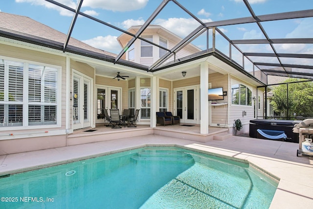 1867 Paradise Moorings Blvd, Middleburg, FL 32068 - swimming pool with french doors, a patio, a hot tub, ceiling fan, and glass enclosure