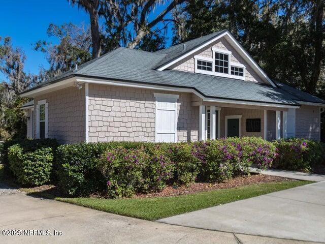 1867 Paradise Moorings Blvd, Middleburg, FL 32068 - view of property exterior featuring a shingled roof and a porch