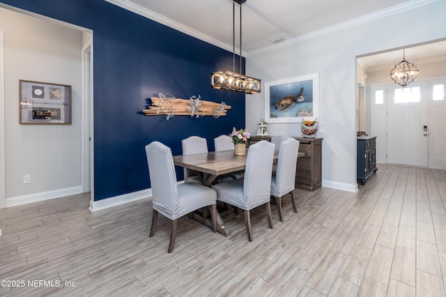 103 Tarbert Ln, Saint Augustine, FL 32092 - dining space with a chandelier, wood finished floors, ornamental molding, and baseboards