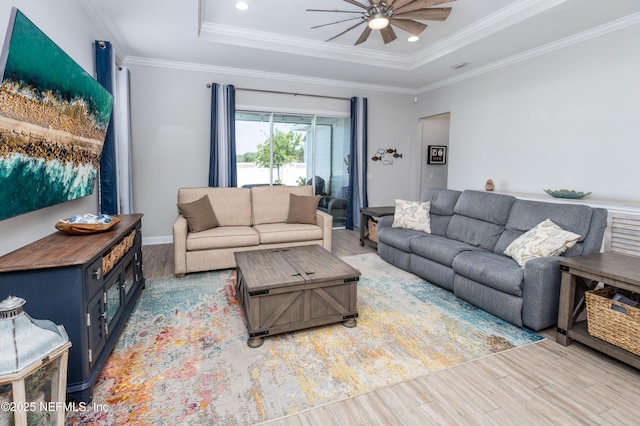 103 Tarbert Ln, Saint Augustine, FL 32092 - living area with wood finished floors, a ceiling fan, a tray ceiling, crown molding, and baseboards