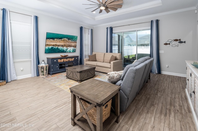 103 Tarbert Ln, Saint Augustine, FL 32092 - living area featuring light wood-style flooring, a raised ceiling, ceiling fan, crown molding, and baseboards