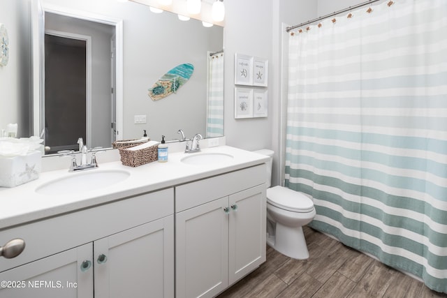 103 Tarbert Ln, Saint Augustine, FL 32092 - bathroom featuring toilet, double vanity, and wood finished floors