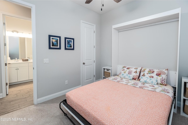 103 Tarbert Ln, Saint Augustine, FL 32092 - bedroom with light carpet, baseboards, a sink, ensuite bath, and ceiling fan