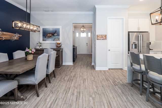 103 Tarbert Ln, Saint Augustine, FL 32092 - dining room featuring a chandelier, ornamental molding, light wood-style flooring, and baseboards