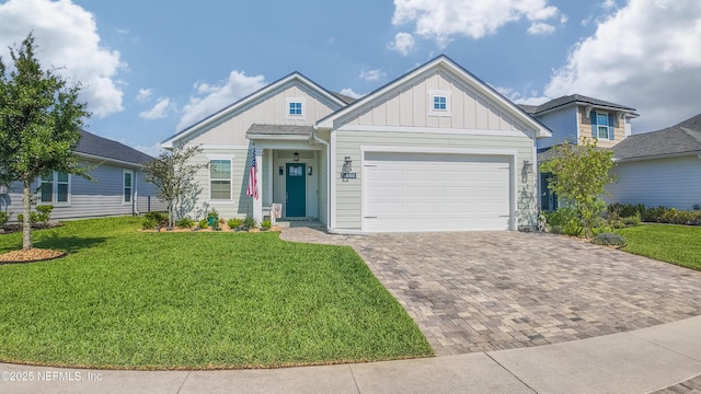 103 Tarbert Ln, Saint Augustine, FL 32092 - view of front of property with board and batten siding, decorative driveway, a garage, and a front yard
