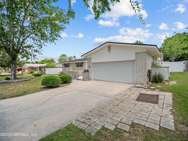 10811 High Ridge Rd, Jacksonville, FL 32225 - view of front of home featuring a garage, driveway, and brick siding