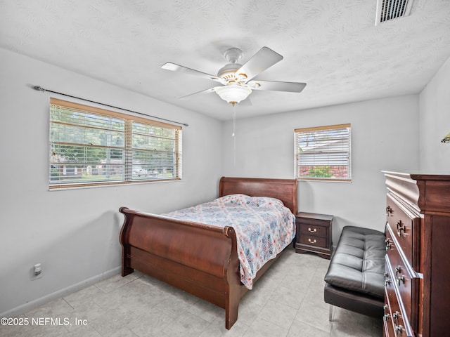 10811 High Ridge Rd, Jacksonville, FL 32225 - bedroom with multiple windows, baseboards, a ceiling fan, and a textured ceiling