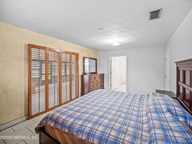 10811 High Ridge Rd, Jacksonville, FL 32225 - bedroom with light tile patterned flooring and a textured ceiling