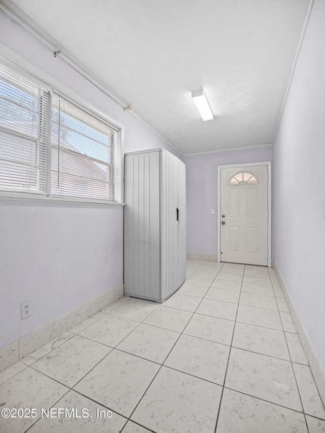 10811 High Ridge Rd, Jacksonville, FL 32225 - foyer featuring light tile patterned flooring and baseboards