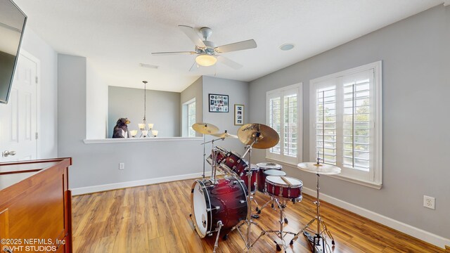 200 Huntston Way, Saint Johns, FL 32259 - playroom with baseboards, wood finished floors, a ceiling fan, and a chandelier