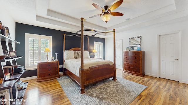 200 Huntston Way, Saint Johns, FL 32259 - bedroom featuring a raised ceiling, wood finished floors, baseboards, and ceiling fan