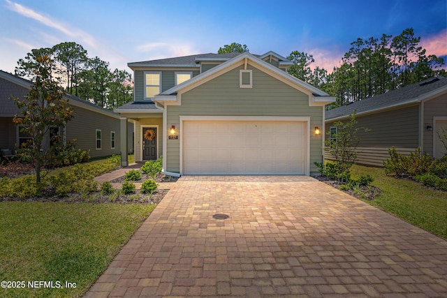 727 Lake Sinclair St, Saint Augustine, FL 32084 - view of front of house featuring decorative driveway, a front yard, and an attached garage