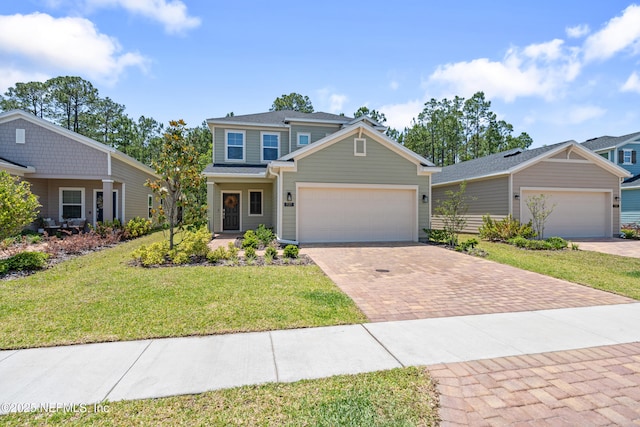 727 Lake Sinclair St, Saint Augustine, FL 32084 - view of front facade with decorative driveway, a front lawn, and a garage