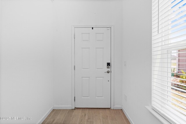 727 Lake Sinclair St, Saint Augustine, FL 32084 - doorway to outside featuring baseboards and light wood-style floors