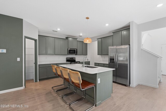 727 Lake Sinclair St, Saint Augustine, FL 32084 - kitchen featuring appliances with stainless steel finishes, a sink, light wood-style flooring, baseboards, and recessed lighting