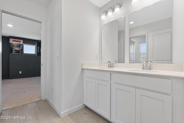727 Lake Sinclair St, Saint Augustine, FL 32084 - bathroom featuring double vanity, wood tiled floors, and baseboards