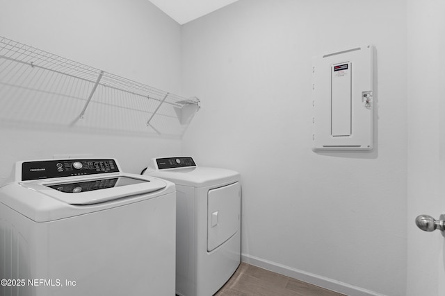 727 Lake Sinclair St, Saint Augustine, FL 32084 - clothes washing area featuring independent washer and dryer, baseboards, electric panel, and wood finished floors