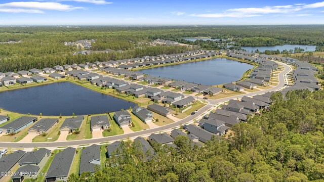 727 Lake Sinclair St, Saint Augustine, FL 32084 - aerial view of property and surrounding area featuring a heavily wooded area, nearby suburban area, and a nearby body of water