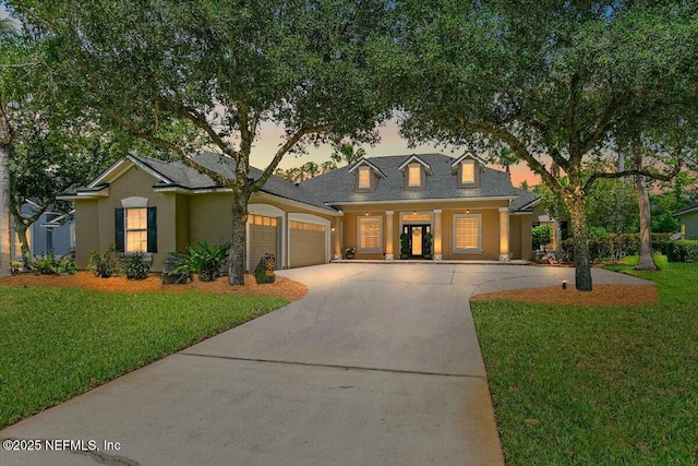 2005 Rivers Own Rd, Saint Augustine, FL 32092 - view of front of home featuring a garage, a front yard, driveway, stucco siding, and a shingled roof