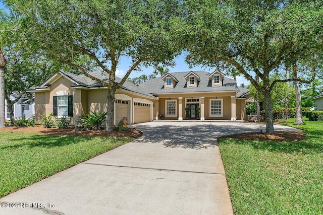 2005 Rivers Own Rd, Saint Augustine, FL 32092 - view of front facade featuring an attached garage, driveway, a front yard, and stucco siding