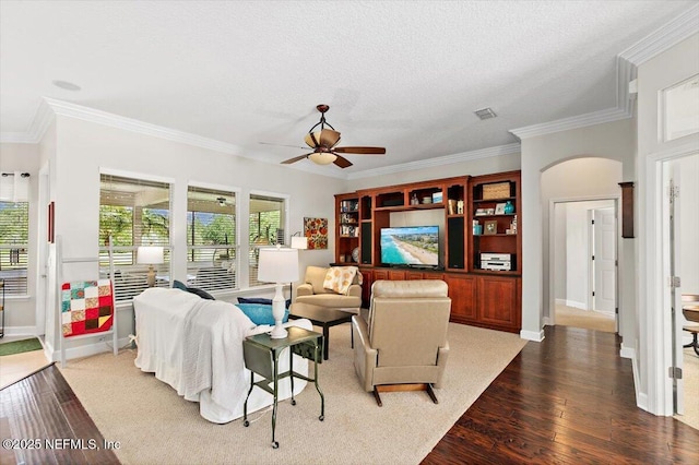 2005 Rivers Own Rd, Saint Augustine, FL 32092 - living area featuring dark wood-type flooring, a ceiling fan, crown molding, arched walkways, and baseboards