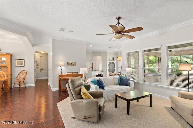 2005 Rivers Own Rd, Saint Augustine, FL 32092 - living area with arched walkways, ornamental molding, baseboards, dark wood finished floors, and a textured ceiling
