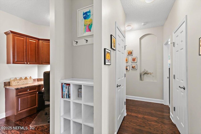 2005 Rivers Own Rd, Saint Augustine, FL 32092 - hall featuring a textured ceiling, dark wood finished floors, an office area, and baseboards