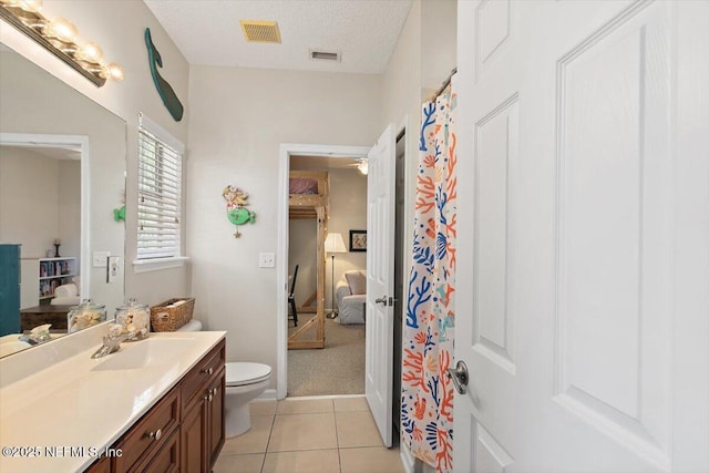 2005 Rivers Own Rd, Saint Augustine, FL 32092 - full bathroom featuring toilet, vanity, ensuite bathroom, tile patterned flooring, and a textured ceiling