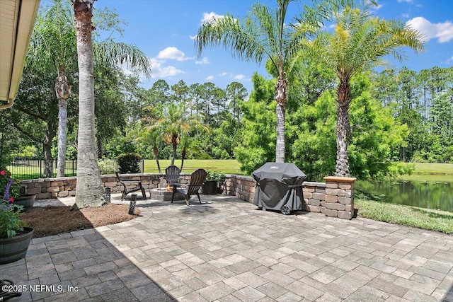 2005 Rivers Own Rd, Saint Augustine, FL 32092 - view of patio featuring an outdoor fire pit, view of scattered trees, a grill, and fence