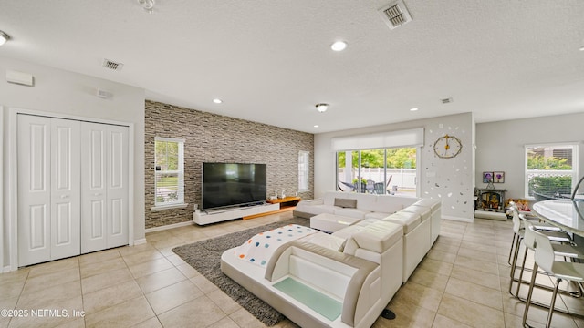 514 Heron Landing Rd, Saint Johns, FL 32259 - living room with light tile patterned floors, healthy amount of natural light, baseboards, a textured ceiling, and recessed lighting