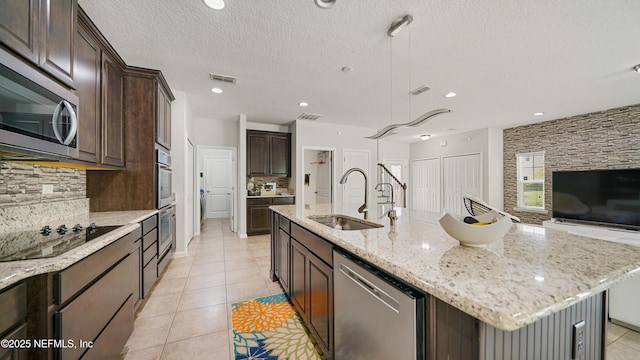 514 Heron Landing Rd, Saint Johns, FL 32259 - kitchen featuring stainless steel appliances, a sink, tasteful backsplash, dark brown cabinetry, and recessed lighting