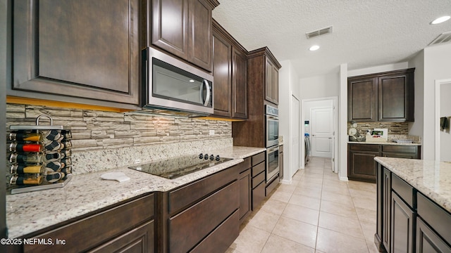 514 Heron Landing Rd, Saint Johns, FL 32259 - kitchen featuring appliances with stainless steel finishes, light stone counters, dark brown cabinetry, light tile patterned floors, and recessed lighting