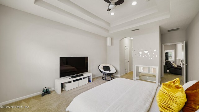 514 Heron Landing Rd, Saint Johns, FL 32259 - bedroom featuring a raised ceiling, carpet floors, arched walkways, baseboards, and recessed lighting