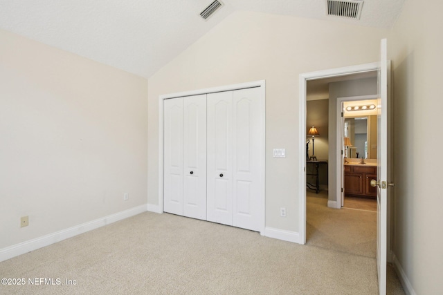 717 E Dorchester Dr, Saint Johns, FL 32259 - unfurnished bedroom with light carpet, vaulted ceiling, a closet, and baseboards