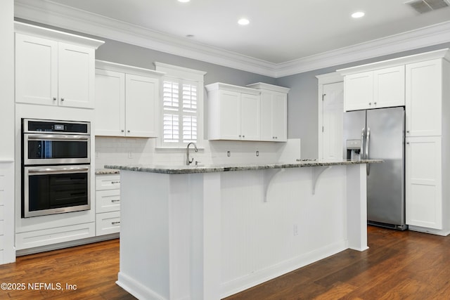 318 Sophia Ter, Saint Augustine, FL 32095 - kitchen with appliances with stainless steel finishes, white cabinetry, light stone countertops, dark wood-type flooring, and crown molding