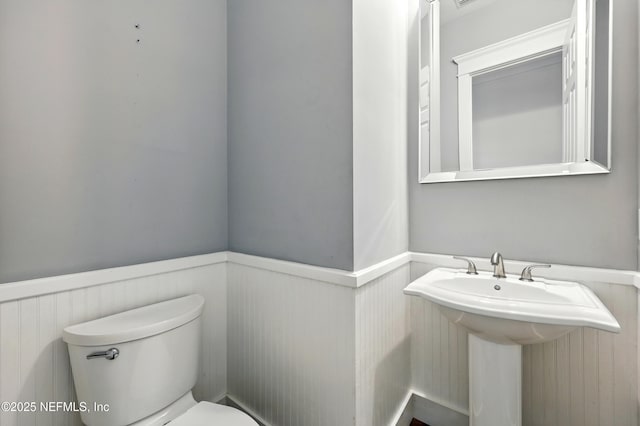 318 Sophia Ter, Saint Augustine, FL 32095 - bathroom with wainscoting, a sink, and toilet