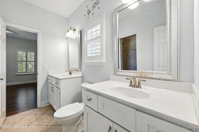 318 Sophia Ter, Saint Augustine, FL 32095 - bathroom with two vanities, tile patterned floors, toilet, a shower, and baseboards